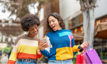 girls shopping looking at phone